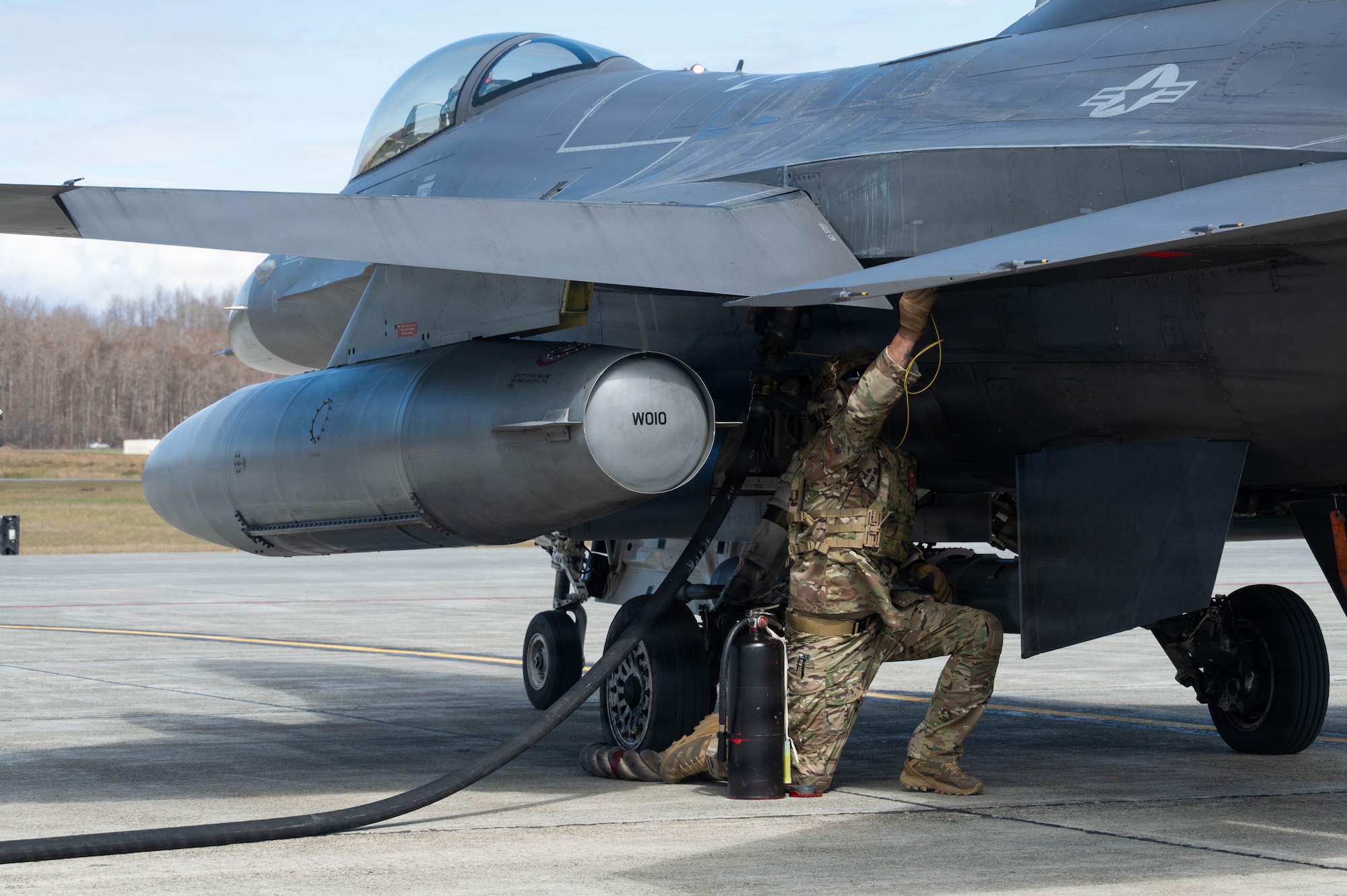 U.S. Air Force Master Sgt. Tyler Vasquez, 176th Logistics Readiness squadron fuels management specialist, connects equipment to an F-16 Fighting Falcon assigned to the 18th Fighter Interceptor Squadron during a forward arming and refueling point operation at Joint Base Elmendorf-Richardson, Alaska, May 15, 2026.