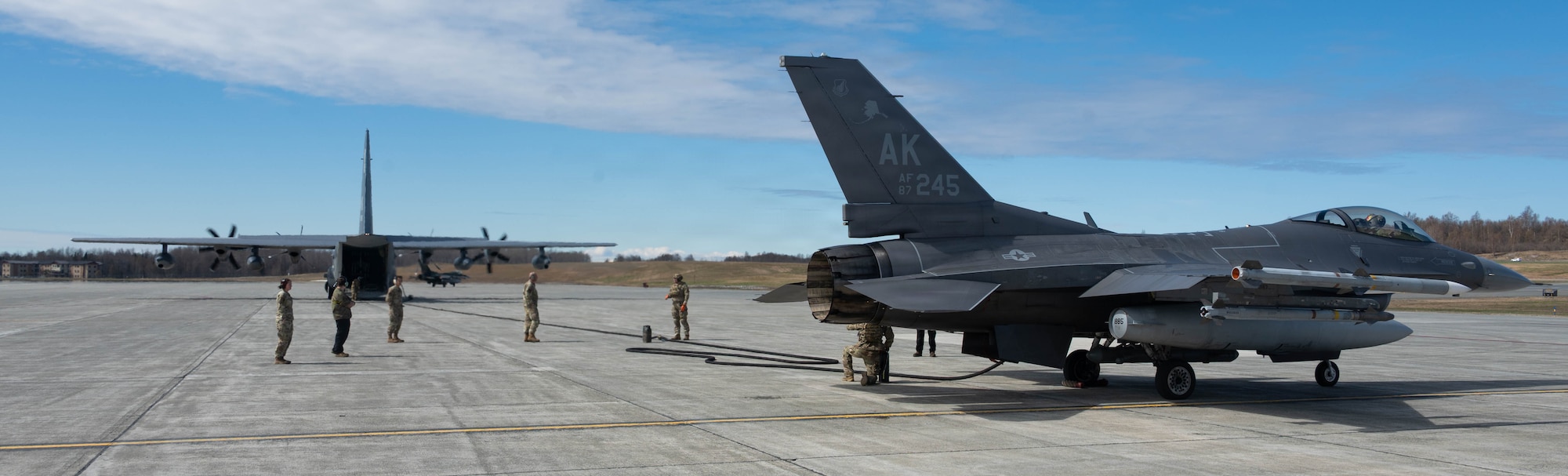 A U.S. Air Force F-16 Fighting Falcon assigned to 18th Fighter Interceptor Squadron is connected for refueling from a HC-130J Combat King II assigned to the 211th Rescue Squadron during a forward arming and refueling point operation at Joint Base Elmendorf-Richardson, Alaska, May 15, 2026.