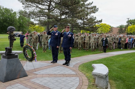Air National Guard Major General Gary Charlton, commander of the New York Air National Guard, left, and Command Chief Master Sergeant Michael Hewson salute while taps played during the New York National Guard headquarters Memorial Day ceremony in Latham, New York, on May 21, 2026.