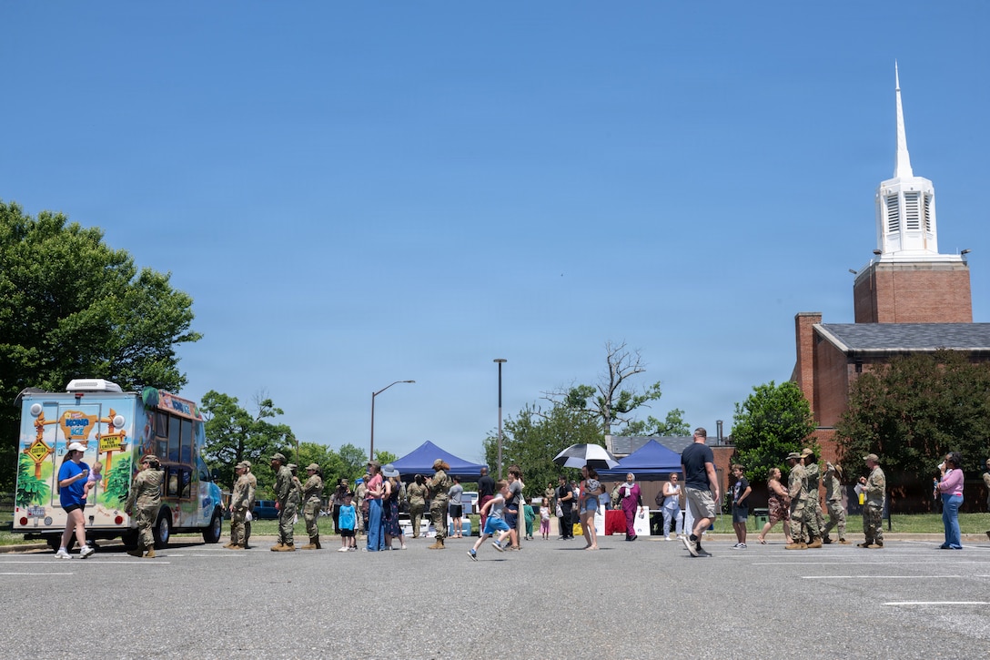 People standing on a long line in front of food truck.