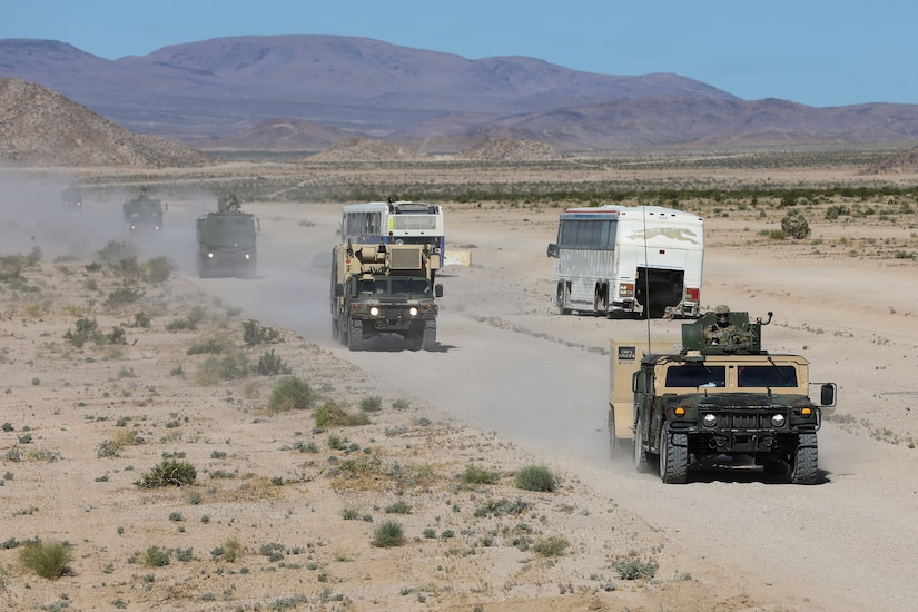 U.S. Army National Guard Soldiers with Kentucky's Bravo Battery, 1st Battalion, 623rd Field Artillery travel in a convoy to the rally point for live-fire exercises on Fort Irwin, California, April 24, 2026.