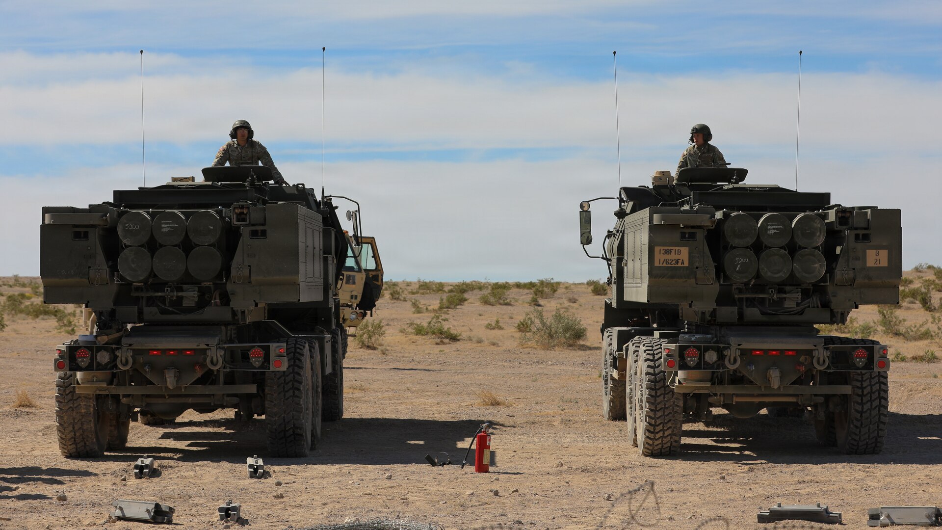 U.S. Army Spc. Vincent Lysons and Spc. Colton Tucker with Kentucky's Bravo Battery, 1st Battalion, 623rd Field Artillery, supervise the loading of rocket pods into the HIMARS in preparation for a live-fire exercise on Fort Irwin, California, April 24, 2026.