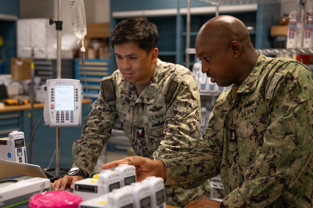 U.S. Navy Hospital Corpsman Chief Petty Officer Antares Zongo, material management equipment division leading chief petty officer at Naval Medical Center San Diego, provides instruction to Hospital Corpsman 2nd Class Arielle Sagum, biomedical equipment technician, at NMCSD, May 19. NMCSD employs more than 5,500 active-duty military personnel, civilians, and contractors in Southern California to deliver exceptional care afloat and ashore. (U.S. Navy photo by Mass Communication Specialist 3rd Class Jason Afable)