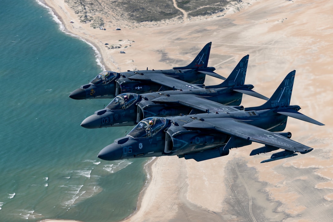 U.S. Marine Corps AV-8B Harrier II aircraft with Marine Attack Squadron (VMA) 223, Marine Aircraft Group 14, 2nd Marine Aircraft Wing, fly over the coast of North Carolina, May 15, 2026. The “sundown” of the AV-8B Harrier II, an iconic aircraft that has supported joint and Marine Corps operations for over 40 years, also represents the dawn of a new era; it paves the way for 2nd MAW’s full transition to the F-35B and C Lightning II. (U.S. Marine Corps photo by Lance Cpl. Perri Wood)