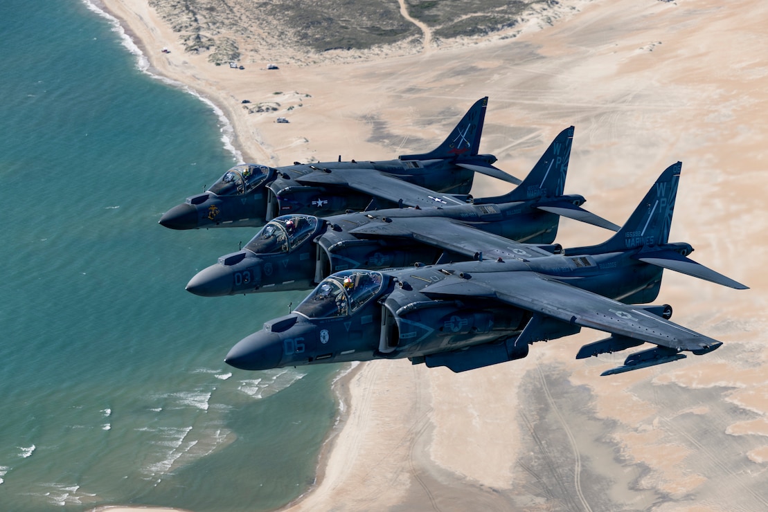 U.S. Marine Corps AV-8B Harrier II aircraft with Marine Attack Squadron (VMA) 223, Marine Aircraft Group 14, 2nd Marine Aircraft Wing, fly over the coast of North Carolina, May 15, 2026. The “sundown” of the AV-8B Harrier II, an iconic aircraft that has supported joint and Marine Corps operations for over 40 years, also represents the dawn of a new era; it paves the way for 2nd MAW’s full transition to the F-35B and C Lightning II. (U.S. Marine Corps photo by Lance Cpl. Perri Wood)
