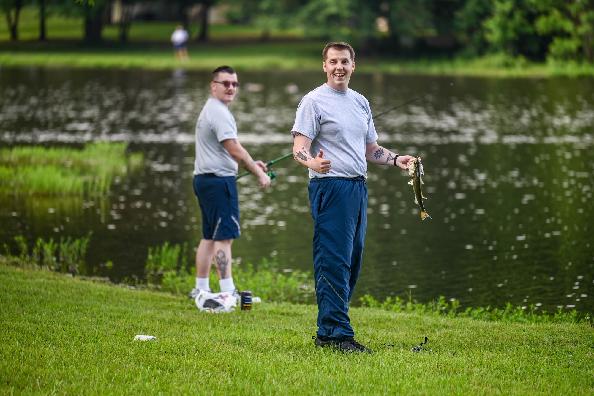 A man holds up a fish he caught.