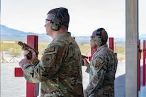 Two men loading pistols
