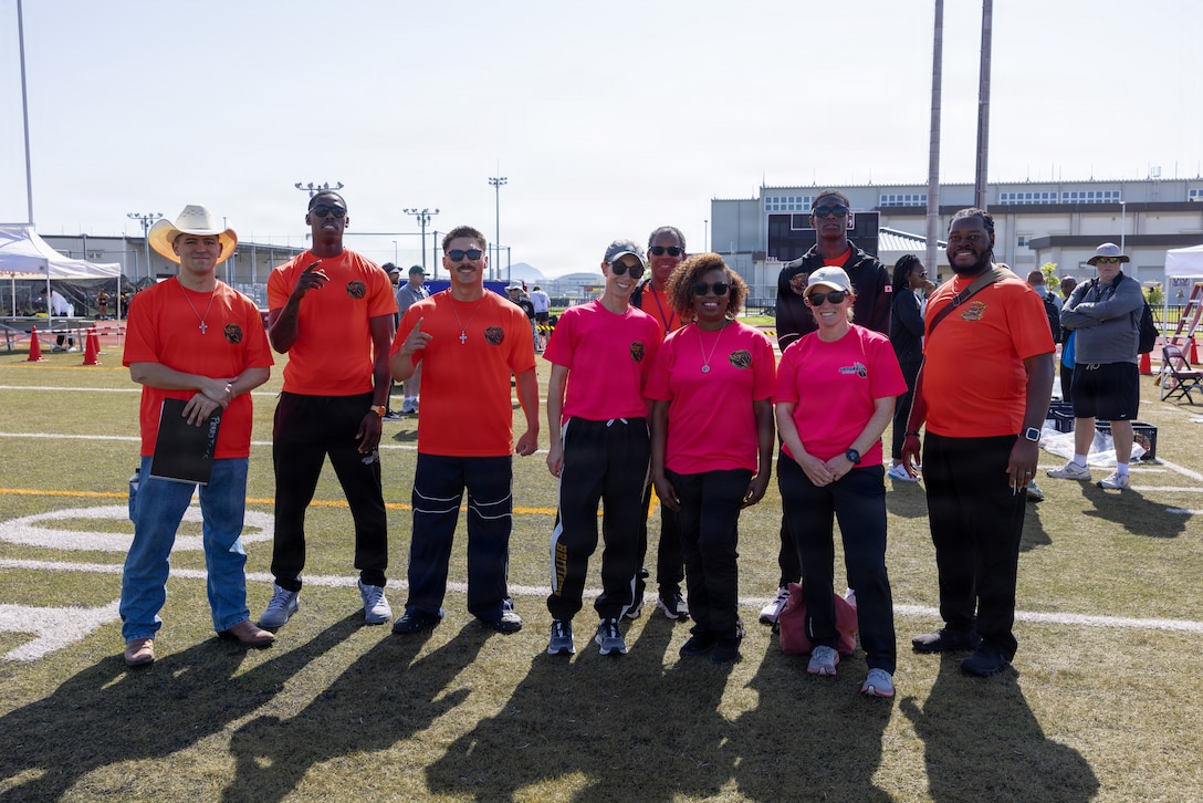 The coaches of the Matthew C. Perry High School spring track and field team pose for a group photo before the Department of Defense Education Activity Pacific Far East Championship 2026 track and field meet at Marine Corps Air Station Iwakuni, Japan, April 27, 2026. Jerron “JJ” Johnson, far right, serves as the airfield manager for MCAS Iwakuni and the director of the M.C. Perry High School track and field team and was recognized for his contributions to the community through both his professional responsibilities and volunteer efforts. (U.S. Marine Corps photo by Cpl. Dahkareo Pritchett)