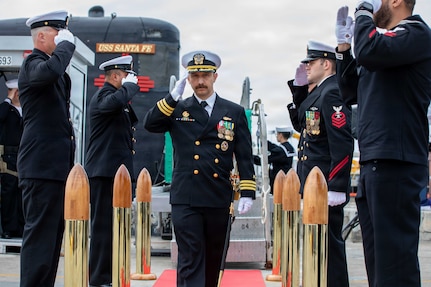 NAVAL BASE POINT LOMA, Calif. (May 15, 2026) – Cmdr. Miguel Recalde, commanding officer, Los Angeles-class fast-attack submarine USS Santa Fe (SSN 763), renders a salute to side boys following the change of command ceremony for Santa Fe onboard Naval Base Point Loma, May 15, 2026. During the ceremony, Cmdr. Eric Knepper was relieved by Recalde as commanding officer of Santa Fe. Santa Fe is assigned to Commander, Submarine Squadron 11, home to four Los Angeles-class fast-attack submarines which are capable of supporting various missions, including anti-submarine warfare, anti-ship warfare, strike warfare and intelligence, surveillance and reconnaissance. (U.S. Navy photo by Mass Communication Specialist 2nd Class Rashan Jefferson)
