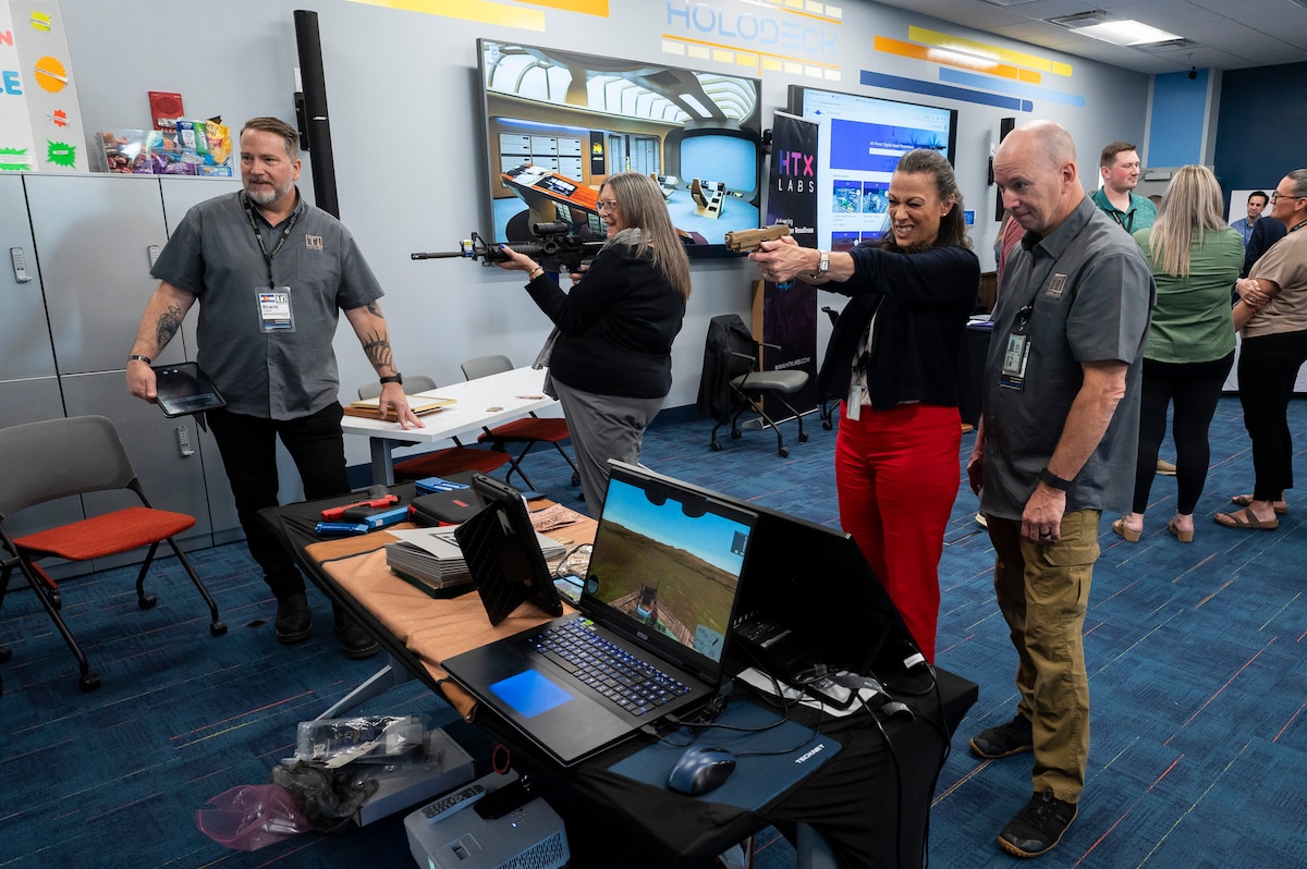 Individuals trying gun simulator.