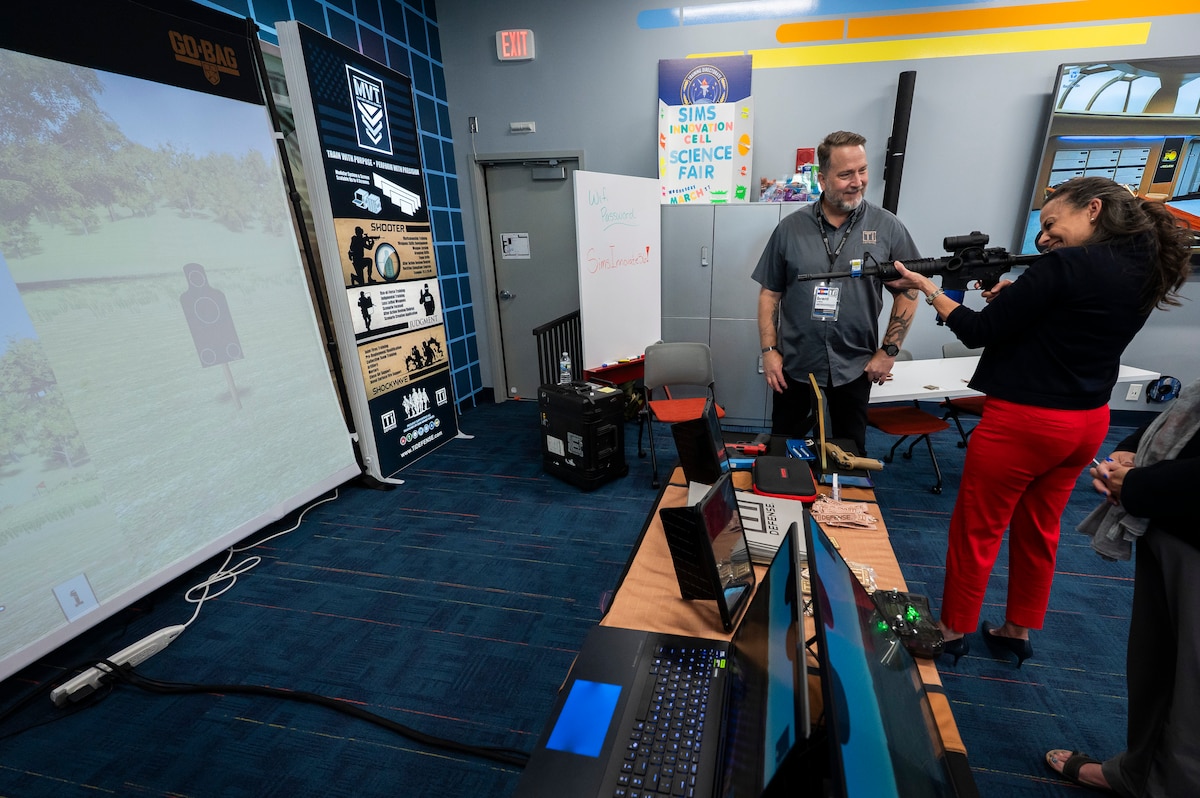 Woman testing gun simulator.