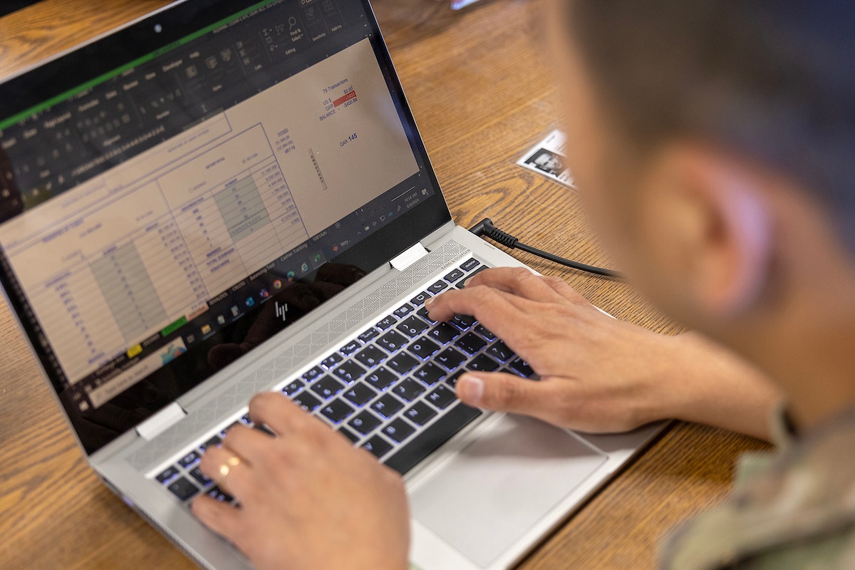 Photo shows someone typing on laptop