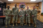 U.S. Air Force Staff Sgt. Desiree Cober, 67th COG religious affairs Airman (center), poses with Master Sgt. Joshua Hunter, 375th Cyberspace Operations Squadron First Sergeant, Capt. David Godley, 67th Cyberspace Operations Group Chaplain, TSgt. Michael Clark and MSgt. Cheyenne Green, 390th COS First Sergeant. (U.S. Air Force photo by Jantzen Floate)