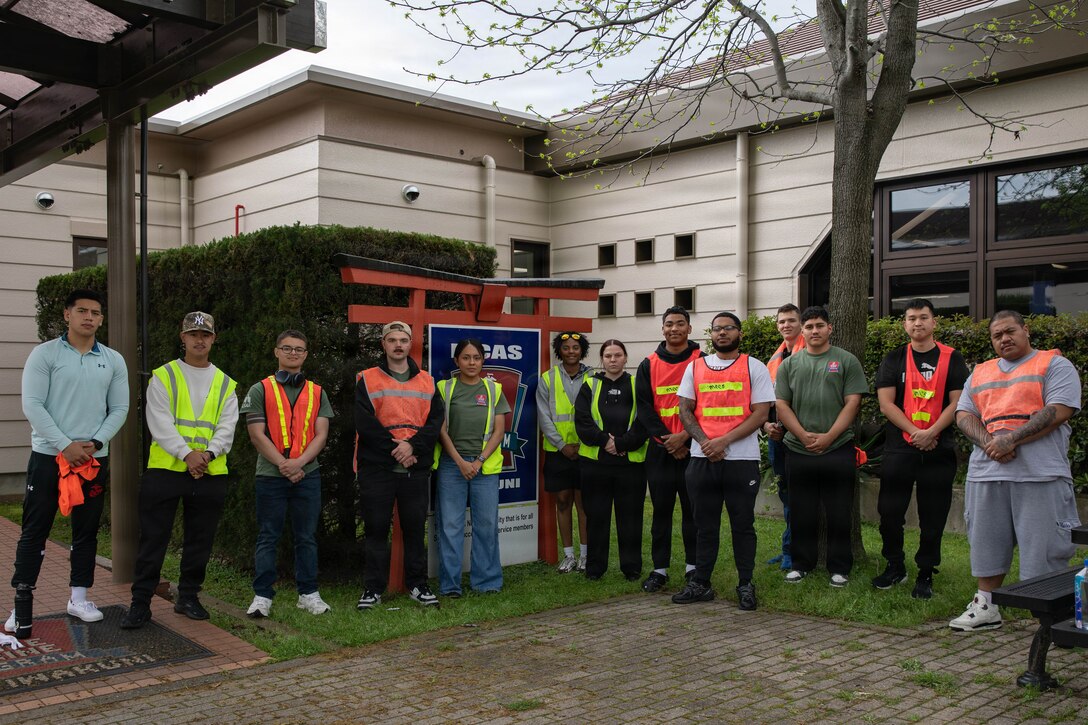 U.S. Marines and Sailors from Marine Corps Air Station Iwakuni, pose for a group photo after picking up trash for a volunteer clean-up event hosted by the MCAS Iwakuni Single Marine Program at MCAS Iwakuni, Japan, April 24, 2026. The MCAS Iwakuni SMP hosted a clean-up as part of the SMP Days of Service, a five-day clean-up event to improve community relations both on and off the installation. (U.S. Marine Corps photo by Lance Cpl. Siwan Lewis)