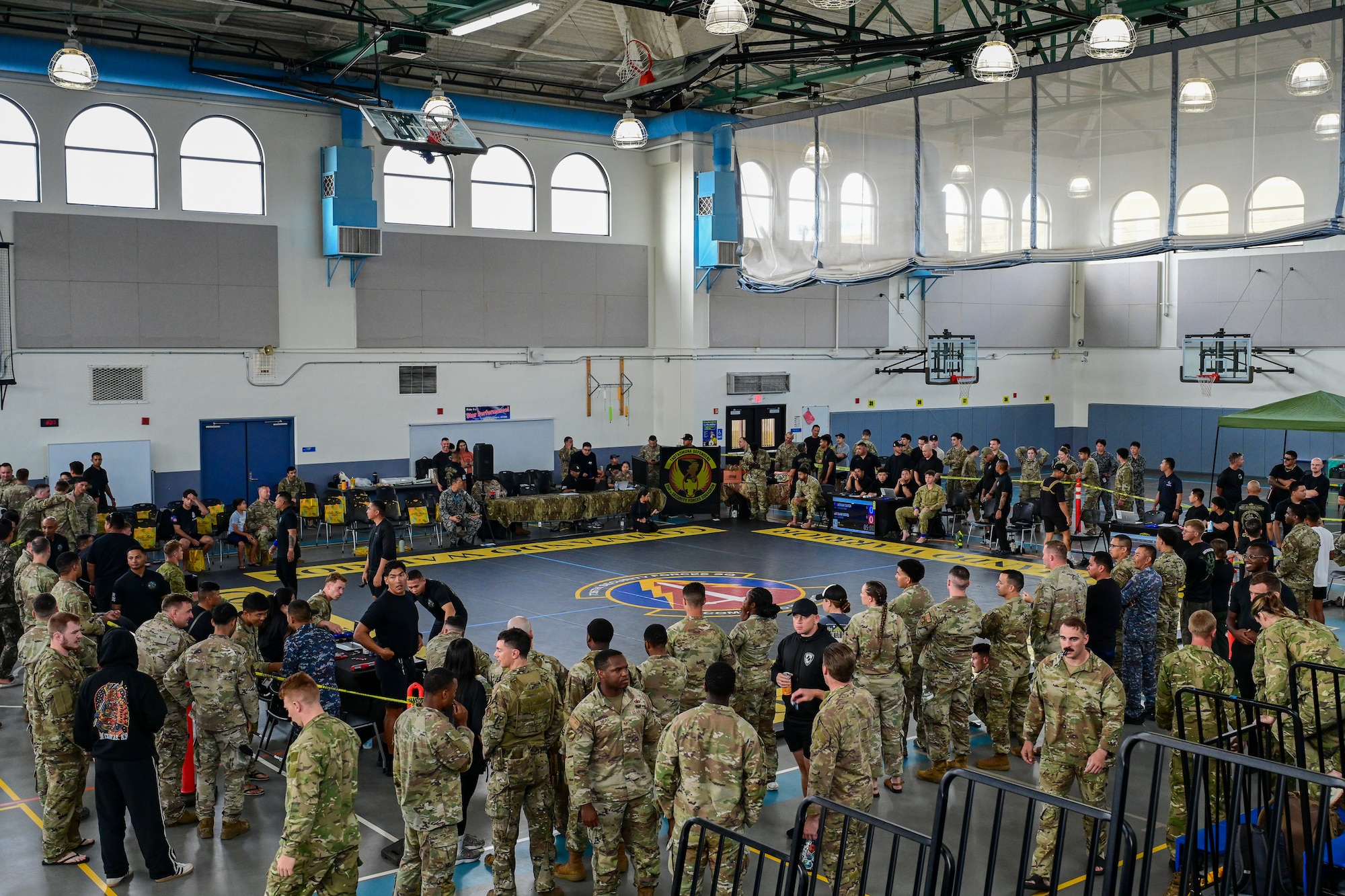 Spectators and participants wait for the start of the combatives portion of Pacific Air Force’s 9th Annual Advanced Combat Skills Assessment Competition at Andersen Middle School, Andersen Air Force Base, Guam, May 22, 2026.