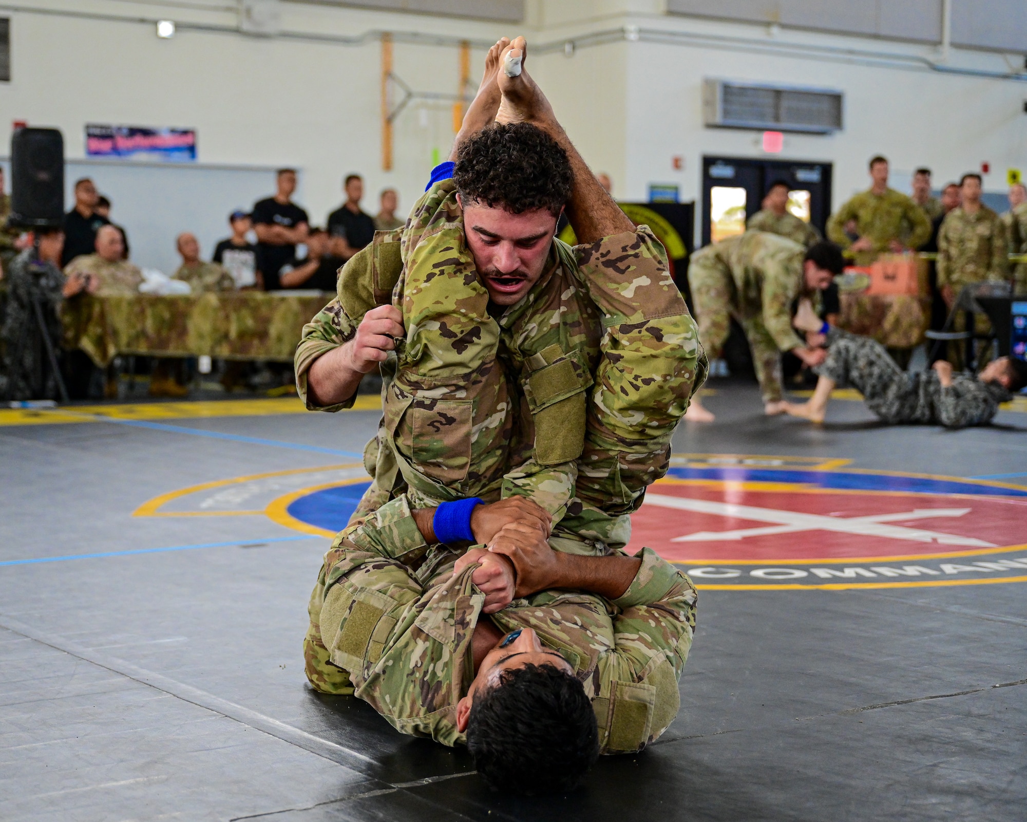 U.S. Security Forces Airmen grapple during the combatives portion of Pacific Air Force’s 9th Annual Advanced Combat Skills Assessment Competition at Andersen Middle School, Andersen Air Force Base, Guam, May 22, 2026.