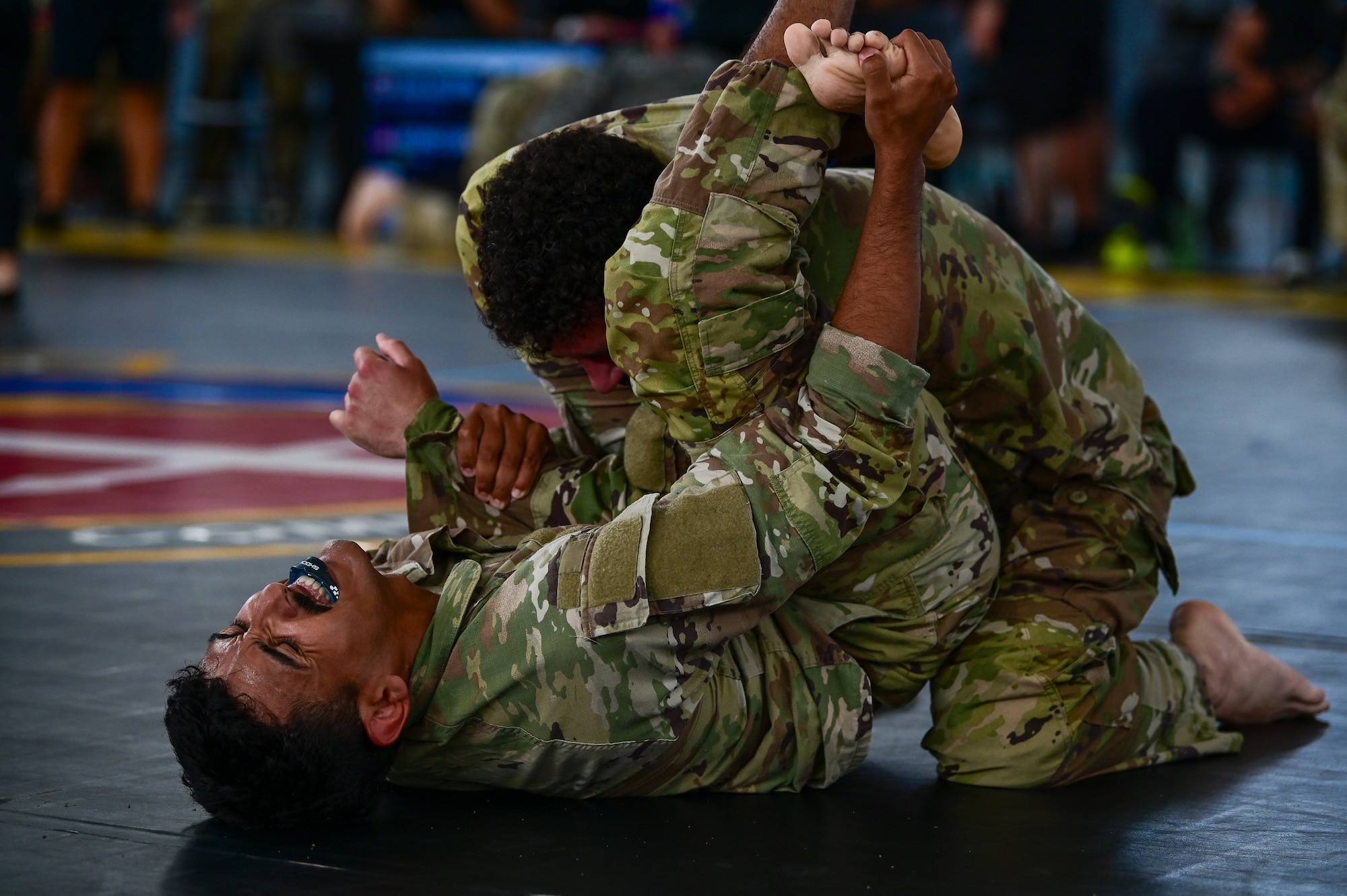 U.S. Security Forces Airmen grapple during the combatives portion of Pacific Air Force’s 9th Annual Advanced Combat Skills Assessment Competition at Andersen Middle School, Andersen Air Force Base, Guam, May 22, 2026.