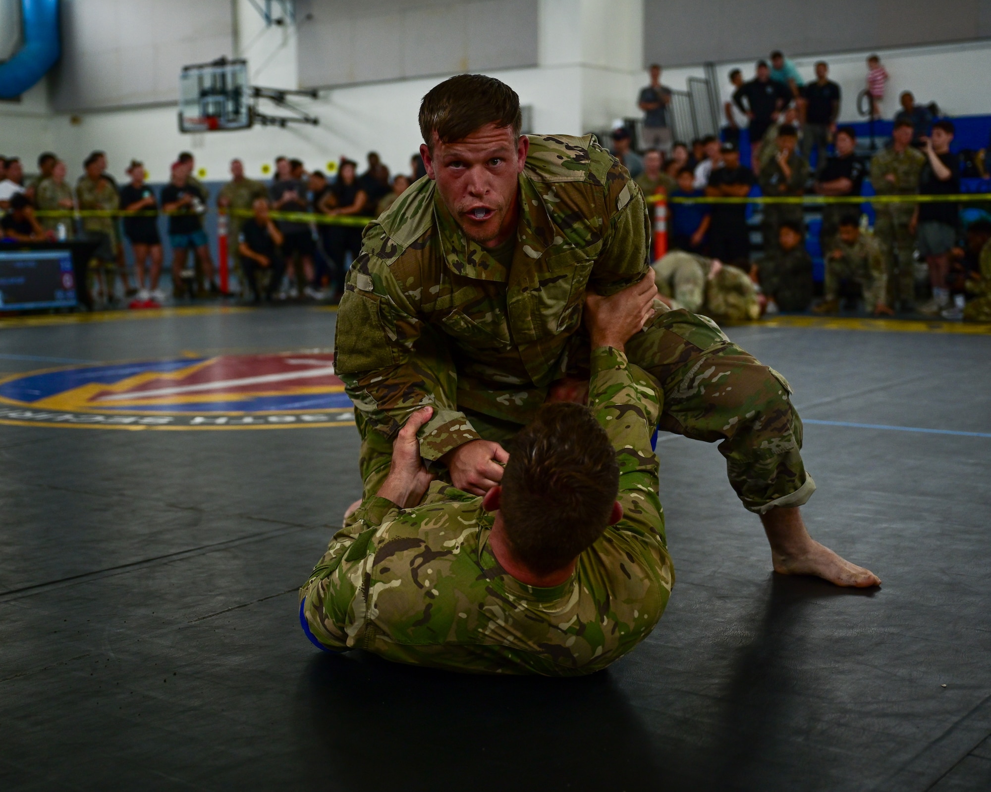 A U.S. Security Forces Airman and a Royal New Zealand Air Force airman grapple during the combatives portion of Pacific Air Force’s 9th Annual Advanced Combat Skills Assessment Competition at Andersen Middle School, Andersen Air Force Base, Guam, May 22, 2026.