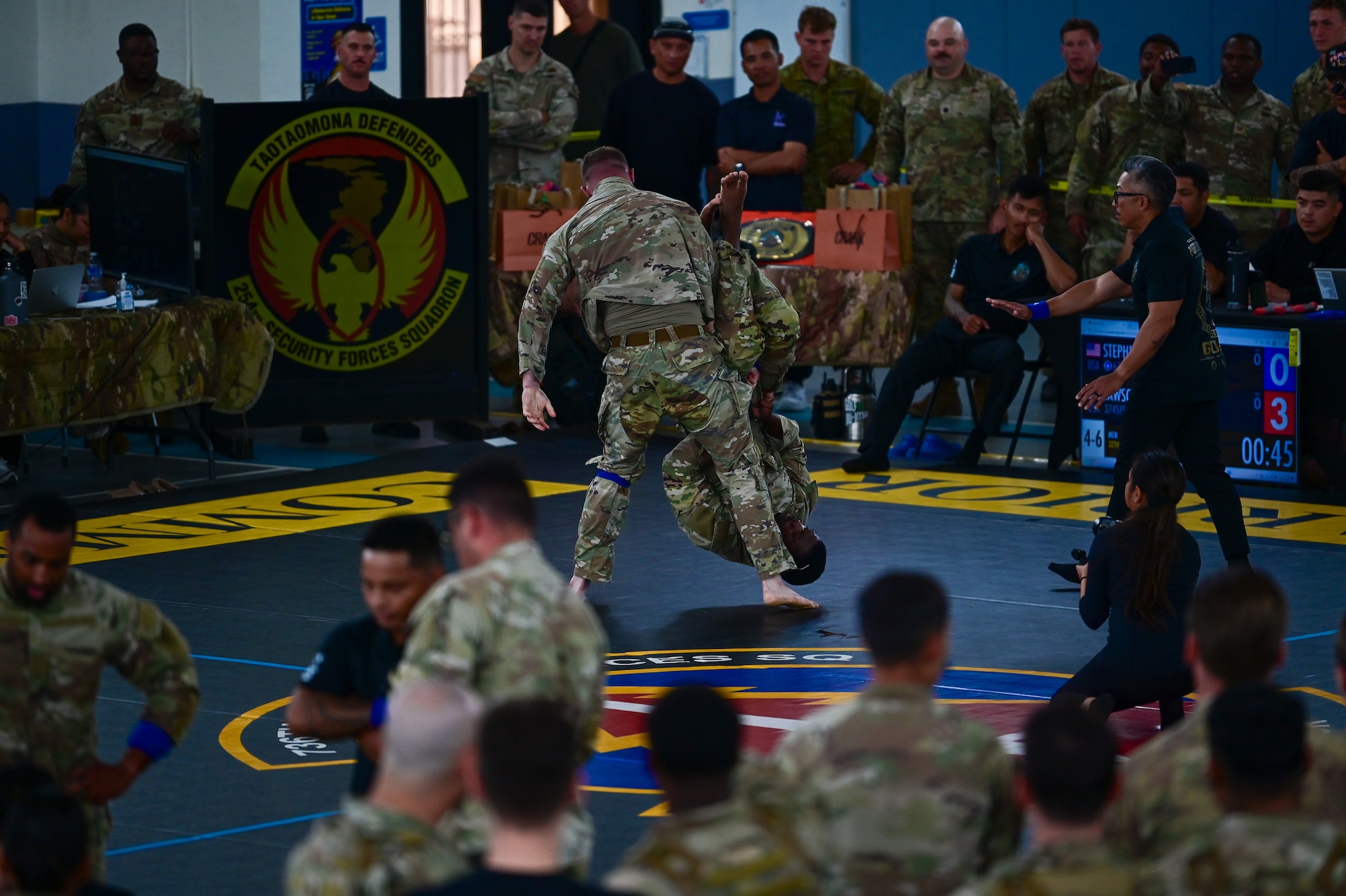 U.S. Security Forces Airmen grapple during the combatives portion of Pacific Air Force’s 9th Annual Advanced Combat Skills Assessment Competition at Andersen Middle School, Andersen Air Force Base, Guam, May 22, 2026.