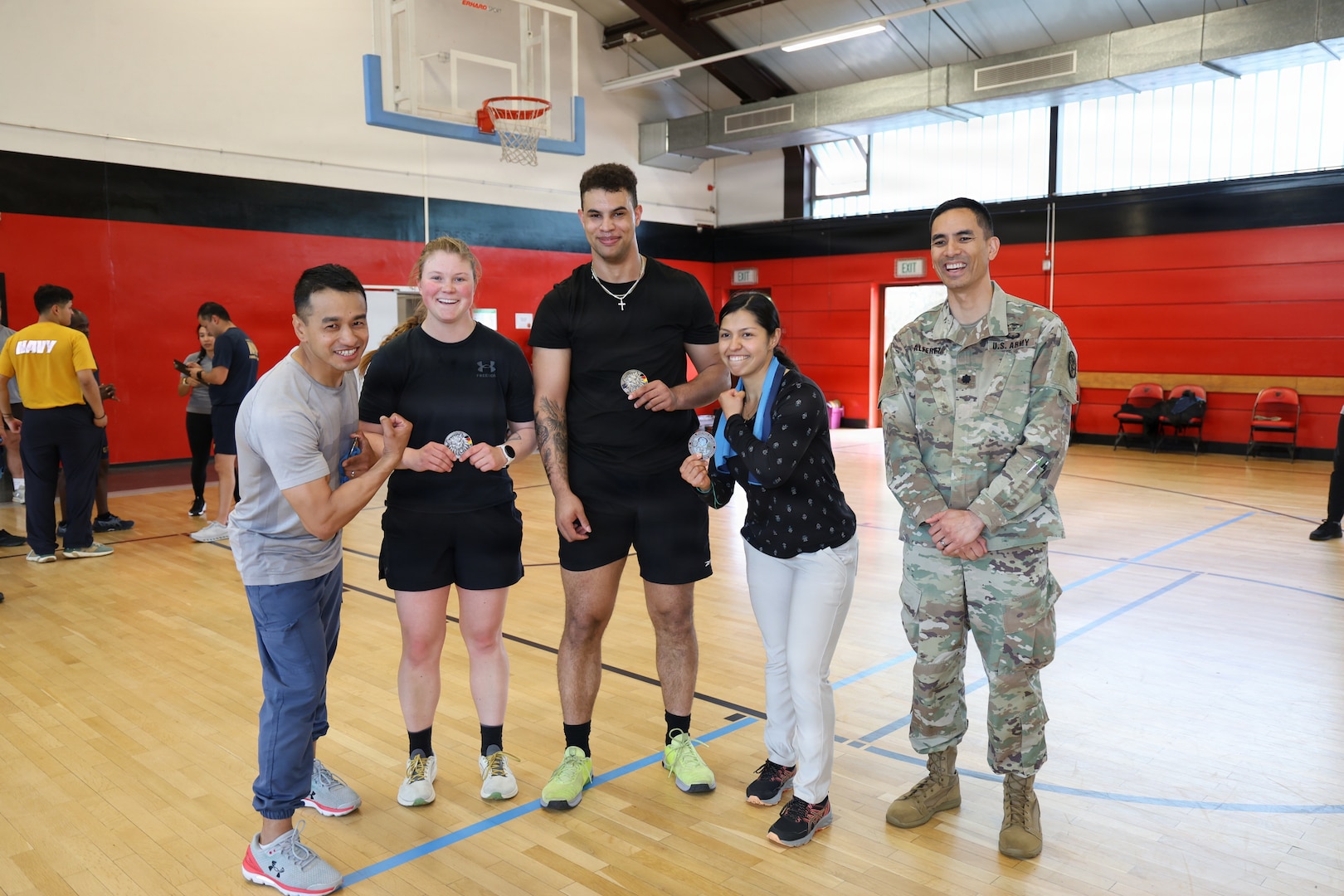 Staff Sgt. Santosh Gurung, 1st Lt.  Brookelyn Heiss, Pfc. Michael McDade, Staff Sgt Maria Rodriguez, pose with Lt. Col. Christopher Alferez, commander of the Medical Readiness Battalion at Landstuhl Regional Medical Center after receiving a MRB commander’s coin for winning second-place during the Team Fitness Competition, May 18, at the LRMC fitness center, concluded the installation's month-long observance of Mental Health Awareness Month.
