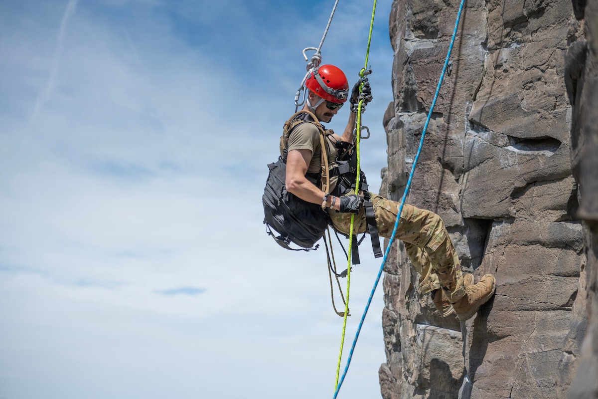 Staff Sgt. Benjamin Noel, a fire protection specialist assigned to the 124th Civil Engineer Squadron, rappels down a cliff face during mountain rescue training at Shaw Mountain in Boise, Idaho, May 8, 2026. The training prepared firefighters to locate and safely recover simulated victims using rope rescue systems and mapped search techniques. (U.S. Air National Guard photo by Airman 1st Class Sarah Welch)