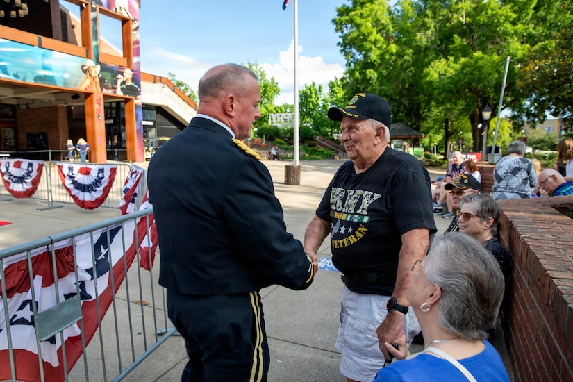 Lt. Gen. Robert Harter, on the left, smiles and speaks with a Vietnam veteran outside the Grand Ole Opry before the annual Salute The Troops show.