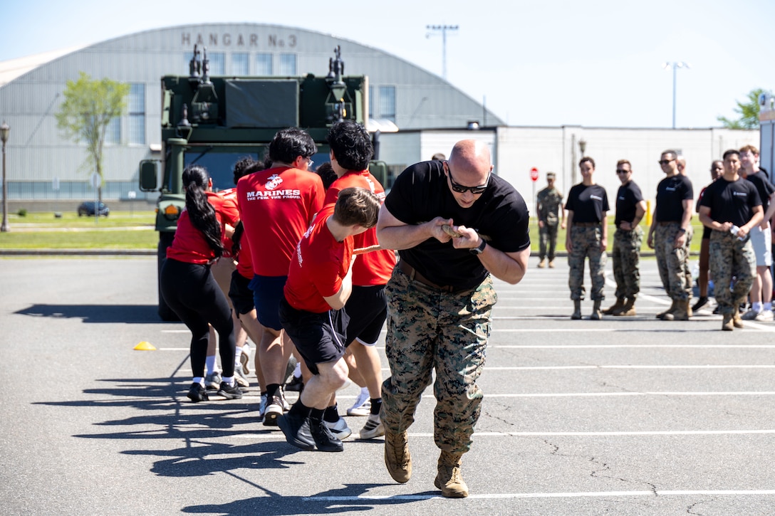 U.S. Marine Corps Gunnery Sgt. David Gonzales, the station commander for Recruiting Sub-station New Haven, Recruiting Station Springfield, pulls a vehicle with his poolees during the recruiting station's annual pool function at Westover Air Reserve Base, Massachusetts, May 16, 2026. The annual pool function is held to prepare poolees for the rigors of recruit training. (U.S. Marine Corps photo by Sgt. Hernan Rodriguez)