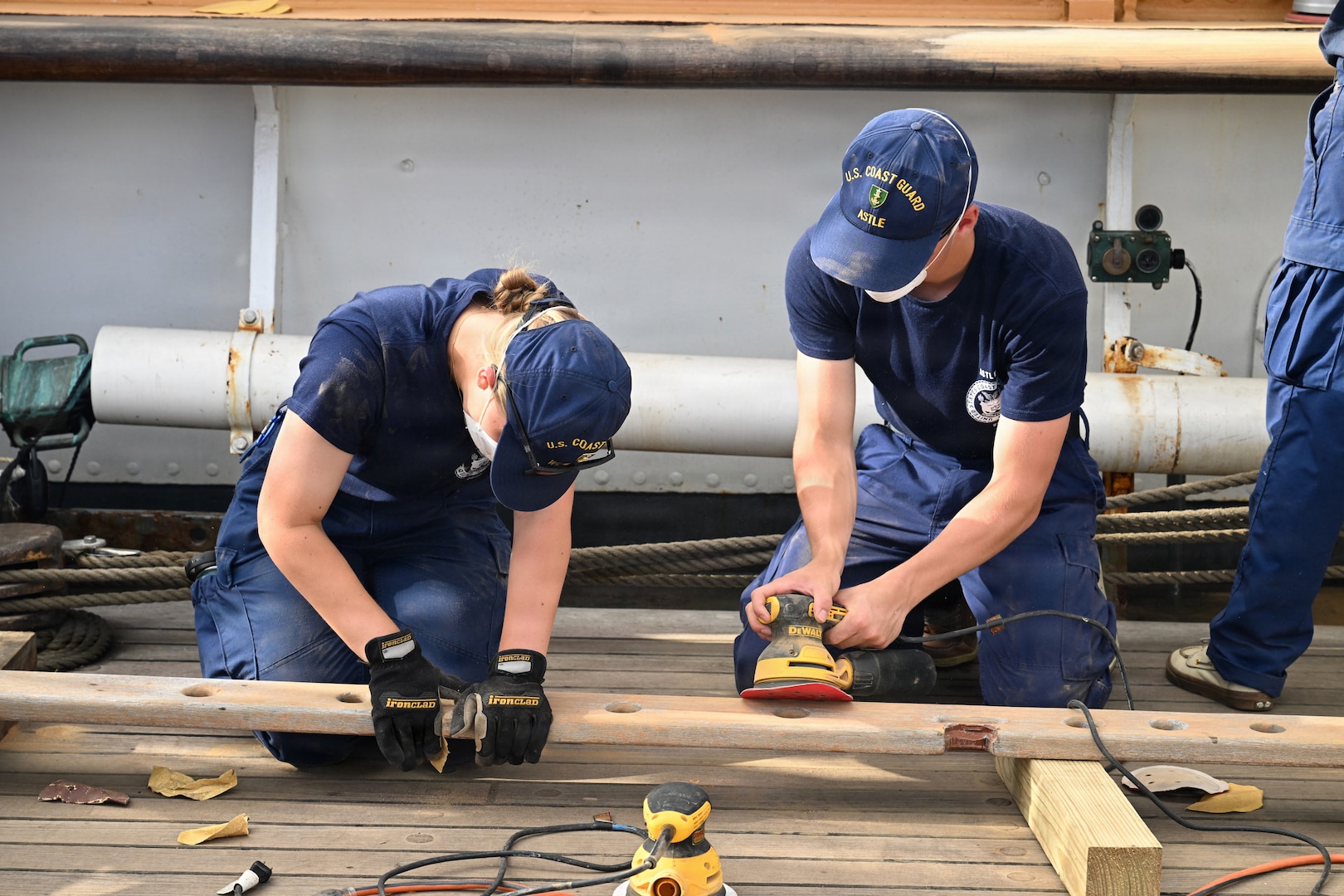 U.S. Coast Guard Academy cadets and crew members assigned to the training barque USCGC Eagle sand the ship's woodwork off the coast of the Florida Keys May 18, 2026. The cadets used manual and power sanders to prep the vessel for paint ahead of participating in America 250 events.