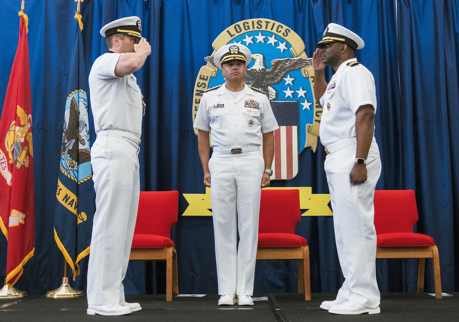 Two men salute each other.
