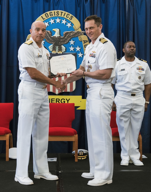 Two men holding an award.