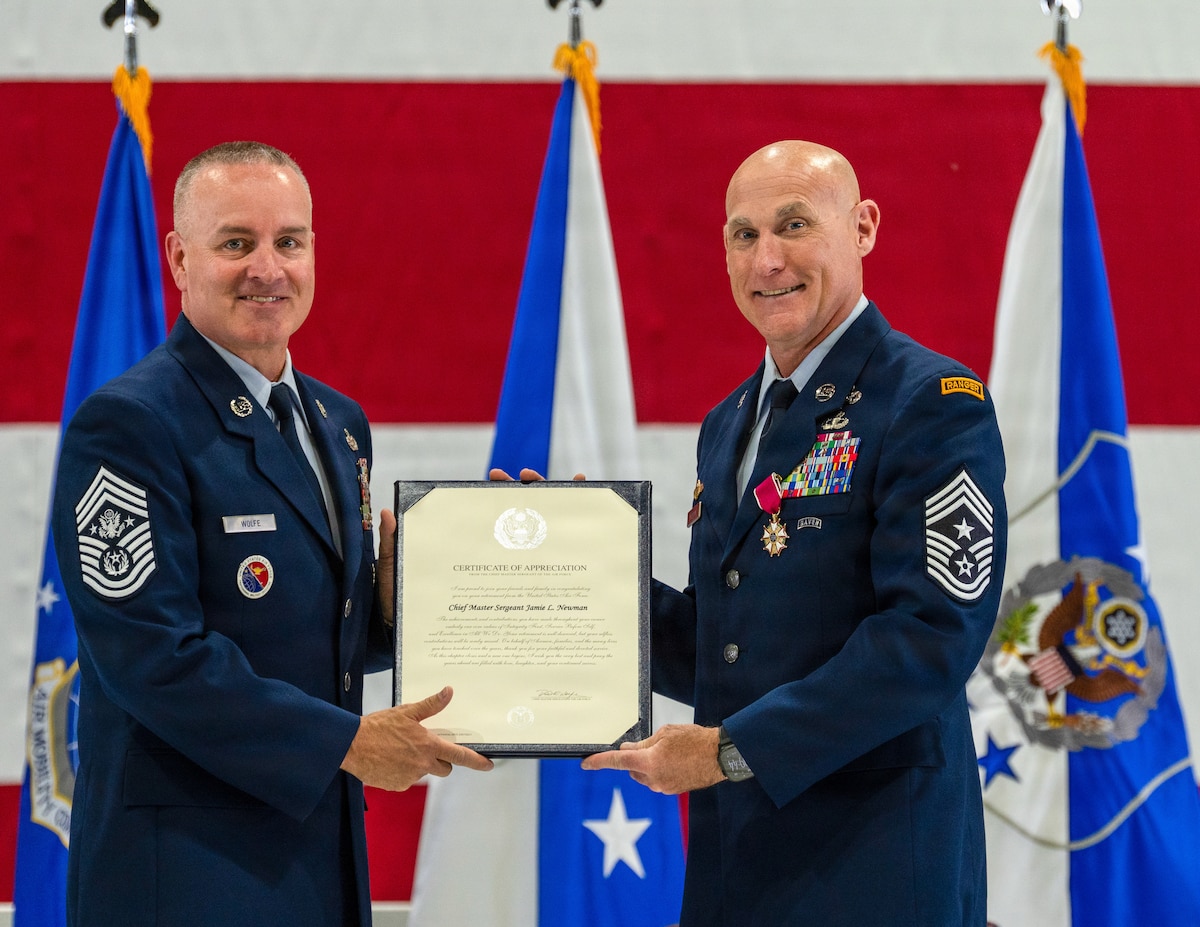 Two Airmen stand for a photo