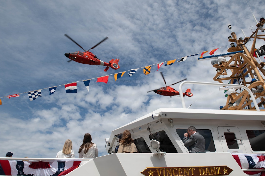 Two U.S. Coast Guard MH-65 Dolphin helicopters fly over the Coast Guard Cutter Vincent Danz (WPC 1162) following the cutter’s commissioning ceremony in New York City, May 22, 2026. The Vincent Danz is the 62nd Fast Response Cutter and honors Petty Officer 2nd Class Vincent Danz, a New York City police officer and Coast Guard reservist who died responding to the September 11, 2001, attacks. (U.S. Coast Guard photo by Marco A. Gutierrez Rosales)