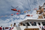 Two U.S. Coast Guard MH-65 Dolphin helicopters fly over the Coast Guard Cutter Vincent Danz (WPC 1162) following the cutter’s commissioning ceremony in New York City, May 22, 2026. The Vincent Danz is the 62nd Fast Response Cutter and honors Petty Officer 2nd Class Vincent Danz, a New York City police officer and Coast Guard reservist who died responding to the September 11, 2001, attacks. (U.S. Coast Guard photo by Marco A. Gutierrez Rosales)