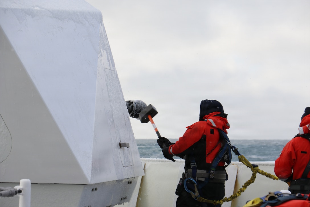 U.S. Coast Guard Petty Officer 2nd Class Gavin Alatar, a crewmember aboard U.S. Coast Guard Cutter Waesche (WMSL 751) breaks ice off of the MK-110 57MM Main Gun in the Bering Sea, Feb. 28, 2026. Waesche operates in harsh environments of while maintaining proficiency and readiness.(U.S. Coast Guard photo by Lt. j.g. Genzo Matua Gonzales)