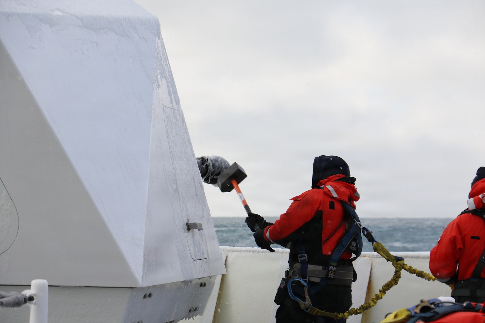 U.S. Coast Guard Petty Officer 2nd Class Gavin Alatar, a crewmember aboard U.S. Coast Guard Cutter Waesche (WMSL 751) breaks ice off of the MK-110 57MM Main Gun in the Bering Sea, Feb. 28, 2026. Waesche operates in harsh environments of while maintaining proficiency and readiness.(U.S. Coast Guard photo by Lt. j.g. Genzo Matua Gonzales)