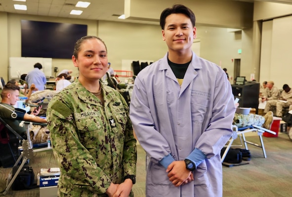 Hospital Corpsman 1st Class April Million (left), leading petty officer for the Adult Medical Care Clinic at Naval Hospital Twentynine Palms, and Hospital Corpsman 3rd Class Reece Curry support a record-breaking blood drive at Marine Corps Air Ground Combat Center Twentynine Palms, May 6, 2026. Million and Curry helped spearhead the successful drive, which collected 117 units of blood in support of military operations overseas and set a new installation record for blood collections during a single event. (U.S. Navy photo by Christopher Jones, NH/NMRTC Twentynine Palms public affairs officer)
