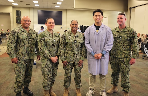 Master Chief Richard Moreno, Hospital Corpsman 1st Class April Million, Capt. Janiese Cleckley, Hospital Corpsman 3rd Class Reece Curry and Cmdr. William "Bill" Lawson (from left to right) pose for a photo during a record-breaking blood drive at Marine Corps Air Ground Combat Center Twentynine Palms, May 6, 2026. The blood drive collected 117 units of blood in support of military operations overseas, setting a new installation record for collections during a single event. (U.S. Navy photo by Christopher Jones, NH/NMRTC Twentynine Palms public affairs officer)