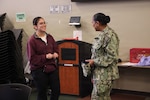 Capt. Janiese Cleckley (right), commanding officer of Navy Medicine Readiness and Training Command Twentynine Palms and director of Naval Hospital Twentynine Palms, meets with staff and donors during a record-breaking blood drive at Marine Corps Air Ground Combat Center Twentynine Palms, May 6, 2026. The blood drive collected 117 units of blood in support of military operations overseas, setting a new installation record for collections during a single event. (U.S. Navy photo by Christopher Jones, NH/NMRTC Twentynine Palms public affairs officer)