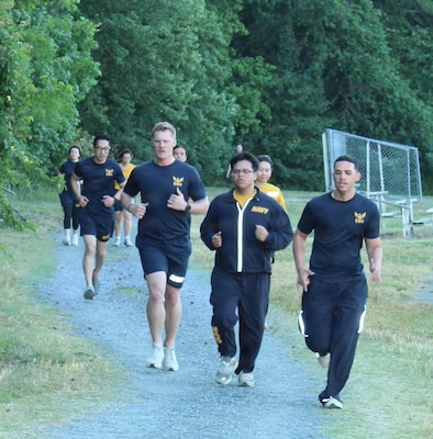 Service members assigned to Navy Medicine Readiness and Training Command (NMRTC) Patuxent River run along the fitness trail at the Naval Air Station Patuxent River Drill Hall Field during the command’s monthly physical training event.

The command took on the 'Murph' challenge—consisting of a 1-mile run, 100 pull-ups, 200 push-ups, 300 squats, and a final 1-mile run—to honor the upcoming Memorial Day weekend and pay tribute to Navy SEAL Lt. Michael Murphy, who was killed in action in Afghanistan in 2005 and posthumously awarded the Medal of Honor.

Led by Command Fitness Leader Chief Hospital Corpsman Amanda Ellis, the command modified the grueling workout into a team event to foster camaraderie, enhance unit cohesion, and ensure all personnel could participate together in the living tribute to America's fallen heroes