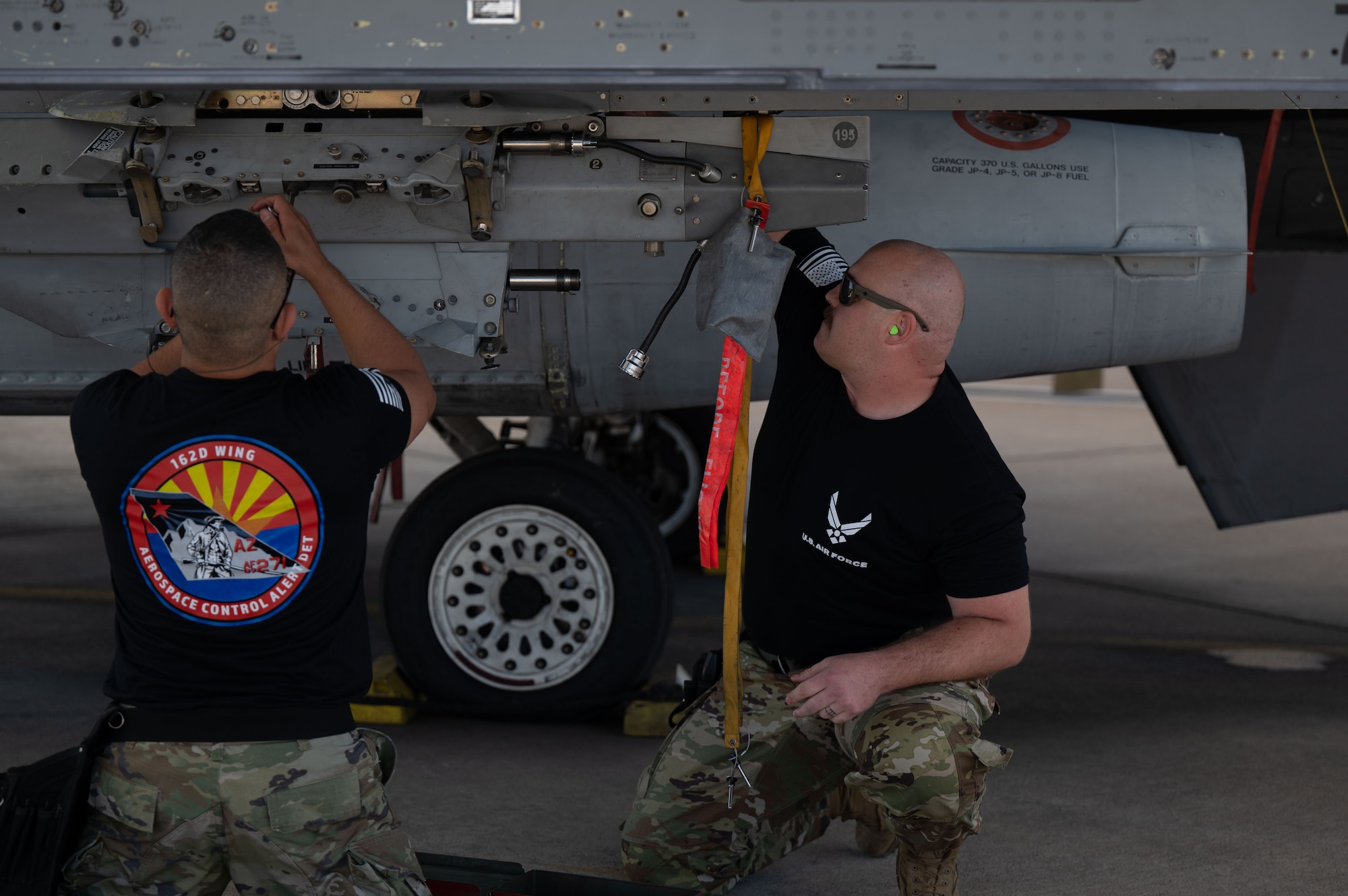 U.S. Air National Guard service members assigned to the 162nd Wing Aerospace Control Alert Detachment (ADET) load munitions onto an F-16 Fighting Falcon during the 2026 Weapons Load Competition at Morris Air National Guard Base, Ariz., May 1, 2026. The ACA DET is a unit directly responsible for domestic airspace defense against emerging threats from strategic competitors. (U.S. Air National Guard photo by Staff Sgt. Guadalupe Beltran)