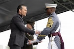 Secretary of War Pete Hegseth awards a diploma to a newly commissioned officer during the U.S. Military Academy class of 2026 graduation ceremony at Michie Stadium in West Point, N.Y., May 23, 2026.