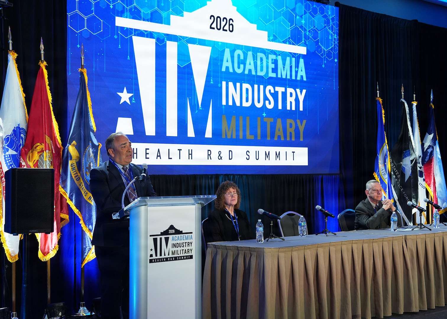 SAN ANTONIO – (May 19, 2026) – Dr. Darrin Frye, chief science director, Naval Medical Research Unit (NAMRU) San Antonio, participated in a “Research & Development Mission and Capability of San Antonio-Based Military Labs” panel during the annual AIM Health R&D Summit held at the Henry B. Gonzalez Convention Center. Joining Frye were Dr. Deb Niemeyer, chief scientist, U.S. Air Force 59th Medical Wing and Dr. Sylvain Cardin, director of research/chief scientific officer, U.S. Army Institute of Surgical Research. Designed to promote cross-sector collaboration in the development of life-saving battlefield technologies, the one-day summit brings together top innovators from academia, industry, and the military to accelerate the research, development, and commercialization of transformative medical technologies. Collaborating and working alongside a wide range of research and development partners keeps Navy Medicine Research & Development (NMR&D) abreast of best practices and advances in medical knowledge. NAMRU San Antonio, part of NMR&D conducts gap-driven combat casualty care, craniofacial, and directed energy research in support of Navy, Marine Corps and joint U.S. warfighter health readiness and lethality while engaged in routine and expeditionary operations. (U.S. Navy photo by Burrell Parmer, NAMRU San Antonio Public Affairs/Released)