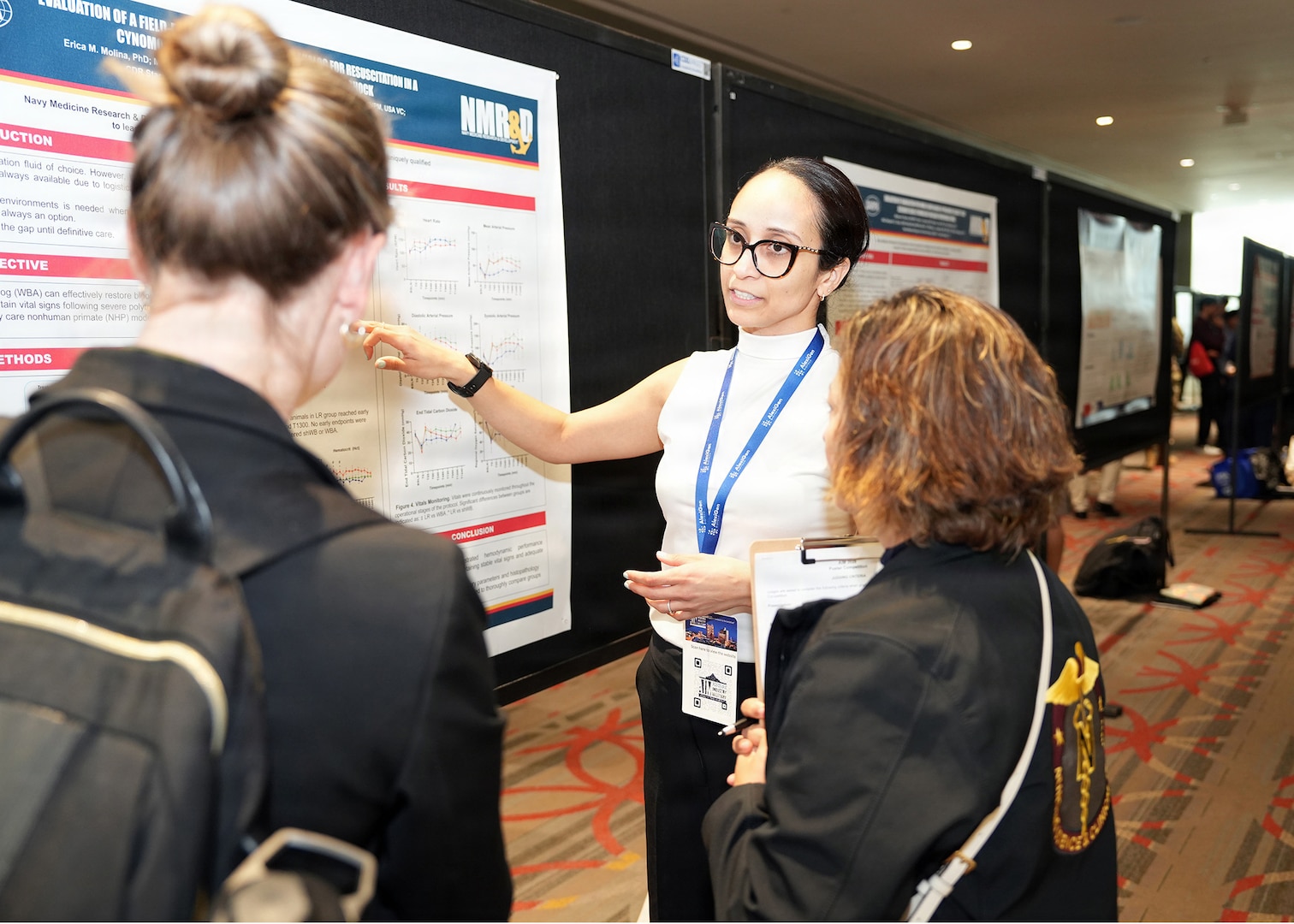 SAN ANTONIO – (May 19, 2026) – Dr. Erica Molina, a research scientist assigned to Naval Medical Research Unit (NAMRU) San Antonio’s Combat Casualty Care and Operational Medicine directorate, presented research on the “Evaluation of a Field-Deployable Whole Blood Analog for Resuscitation of Hemorrhagic Shock” at the annual AIM Health R&D Summit held at the Henry B. Gonzalez Convention Center. Designed to promote cross-sector collaboration in the development of life-saving battlefield technologies, the one-day summit brings together top innovators from academia, industry, and the military to accelerate the research, development, and commercialization of transformative medical technologies. Collaborating and working alongside a wide range of research and development partners keeps Navy Medicine Research & Development (NMR&D) abreast of best practices and advances in medical knowledge. NAMRU San Antonio, part of NMR&D conducts gap-driven combat casualty care, craniofacial, and directed energy research in support of Navy, Marine Corps and joint U.S. warfighter health readiness and lethality while engaged in routine and expeditionary operations. (U.S. Navy photo by Burrell Parmer, NAMRU San Antonio Public Affairs/Released)