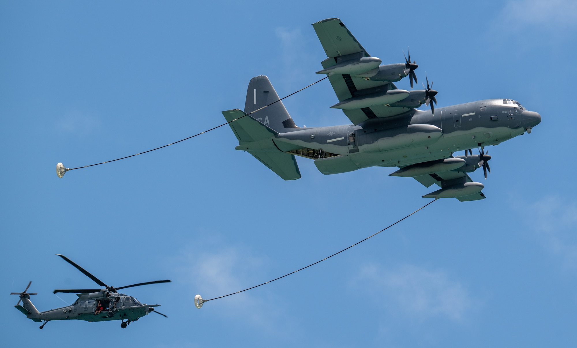 large aircraft refuels helicopter