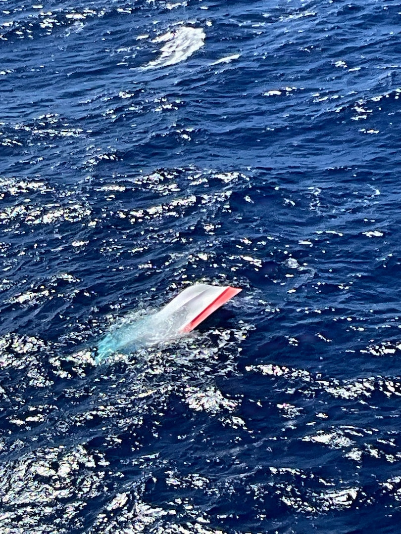 A partially submerged boat floats in the waters off the southwest coast of Oahu May 24, 2026. A Coast Guard Air Station Barbers Point MH-65 Dolphin helicopter crew responded to a report of a partially submerged vessel 19 miles off the Waianae coast of Oahu. (U.S. Coast Guard photo courtesy Coast Guard Air Station Barbers Point)
