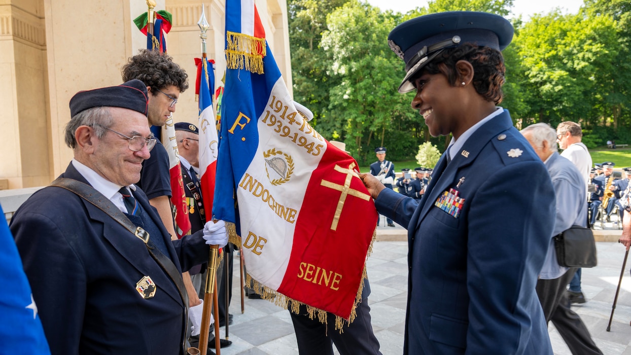 U.S. Air Force Ch, Lt. Col. Michelle Law-Gordon, an individual mobilization augmentee to the U.S. Air Forces in Europe - Air Forces Africa deputy command chaplain, swaps stories with a French Color Guard member during a Memorial Day ceremony held at the Lafayette Escadrille Memorial, Marnes-la-Coquette, France, May 24, 2026.