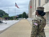 U.S. Army Spc. Shretha Broderick with the Georgia National Guard assigned to Joint Task Force-District of Columbia in support of the DC Safe and Beautiful mission, salutes the American flag while wearing the Freedom 250 Brassard at the DC Armory in Washington, May 21, 2026. About 2,500 National Guard members are supporting the mission, providing critical assistance to the Metropolitan Police Department to help ensure the safety of residents, commuters and visitors throughout the District.