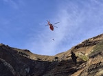A Coast Guard MH-65 Dolphin aircrew from Coast Guard Air Facility Newport lowers Petty Officer 2nd Class Ben Sobels, Coast Guard Aviation Survival Technician onto God's Thumb in Lincoln City, Oregon, May 24, 2026.