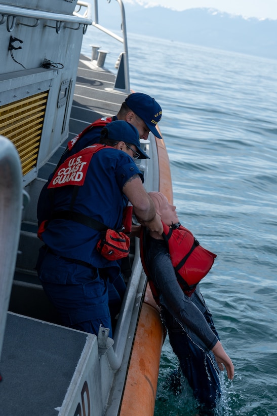 Crewmembers from U.S. Coast Guard Station Port Angeles pull a rescue manikin from the water during a joint search and rescue exercise in the Strait of Juan de Fuca, May 21, 2026.