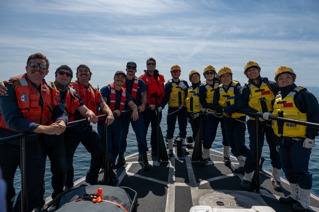 Members of the U.S., Canadian and Japan Coast Guards pose for a group photo during a joint search and rescue exercise in the Strait of Juan de Fuca, May 21, 2026.